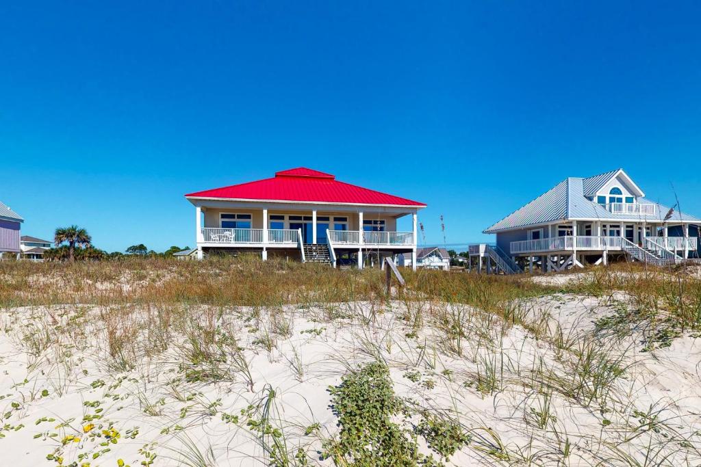 a house with a red roof on the beach at See Escape in St. George Island