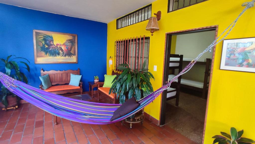 a living room with a hammock in a room at Macondo Hostel in San Gil