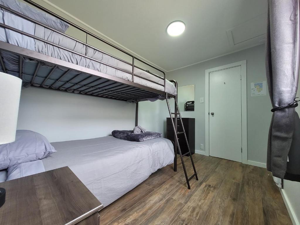 a bedroom with two bunk beds and a table at Beluga Beach House in Churchill