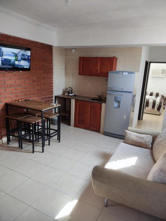 a kitchen with a couch and a table and a refrigerator at Departamento con buena ubicación in Corrientes