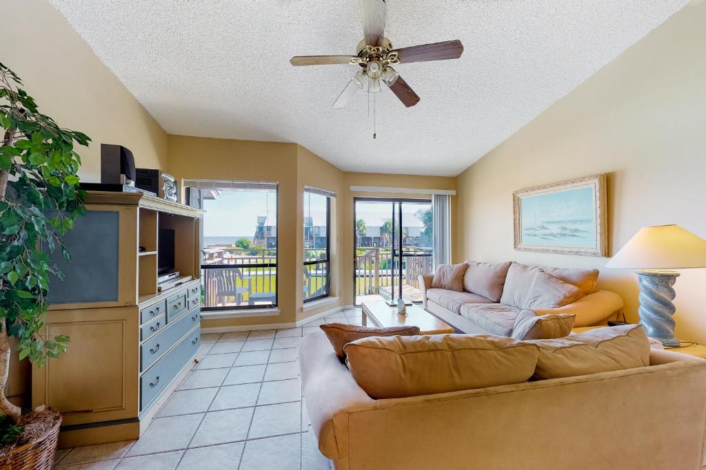 a living room with a couch and a tv at Ocean Mile K-11 in St. George Island