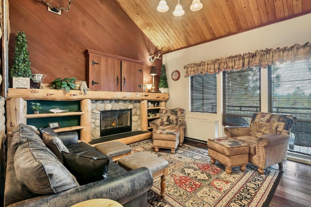 a living room with a couch and chairs and a fireplace at Seventh Mountain 1031 condo in Bend