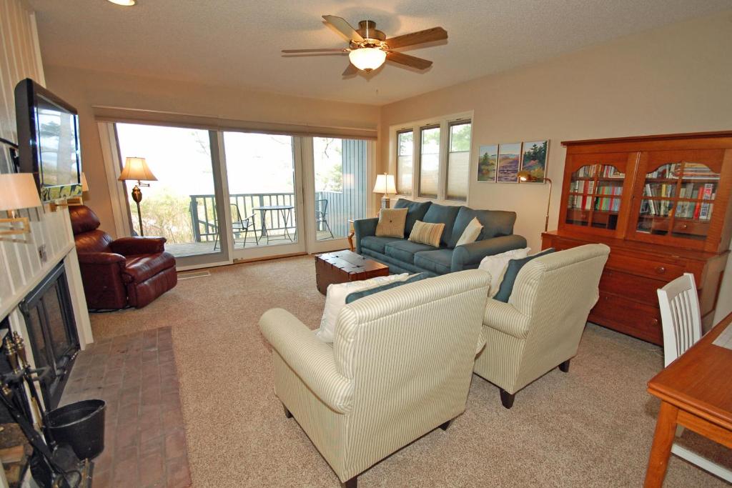 a living room with a couch and chairs and a table at Sandpiper 1 in Glen Arbor