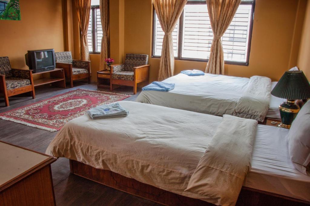 Postel nebo postele na pokoji v ubytování Hotel Metropolitan Kantipur