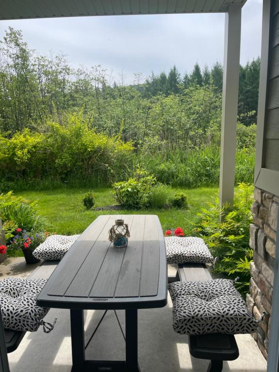 a table and chairs on a patio with a view at Dida in Saint-Sauveur-des-Monts