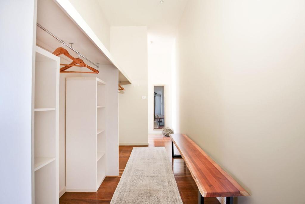 a hallway with a wooden bench in a house at Eclipse Absolute Beachfront with Stunning Views in Culburra Beach