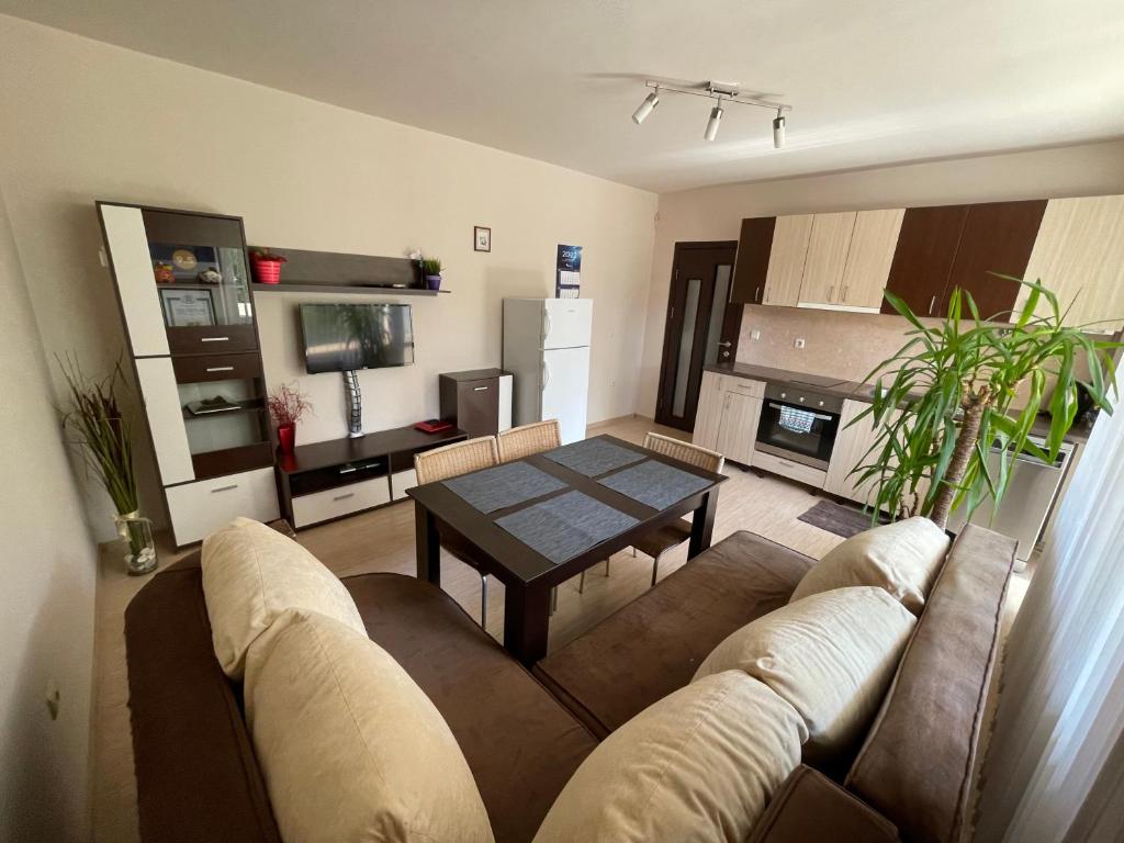 a living room with a couch and a table at Apartment George in Burgas