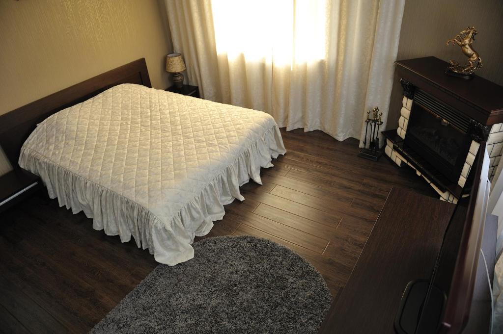 a bedroom with a white bed and a window at Hotel Svetofor in Lgov