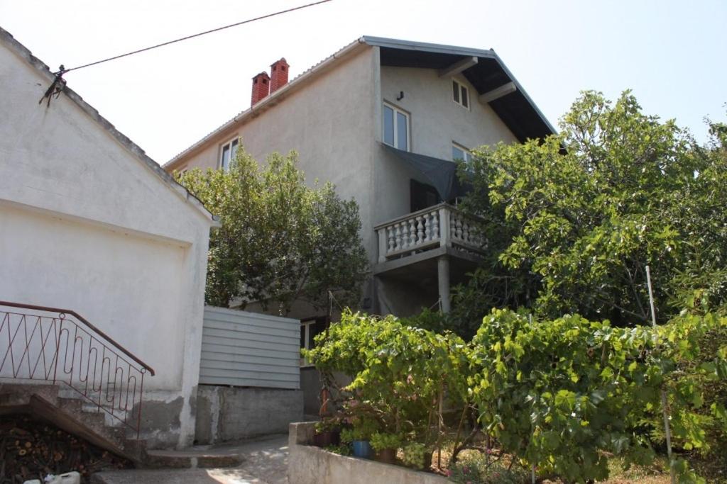 a house with a balcony on the side of it at Apartments by the sea Zaglav, Dugi otok - 8134 in Sali