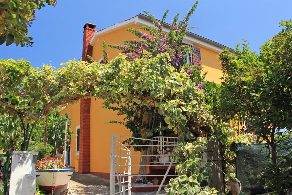 a house with a bunch of plants in front of it at Apartments by the sea Sali, Dugi otok - 8110 in Sali