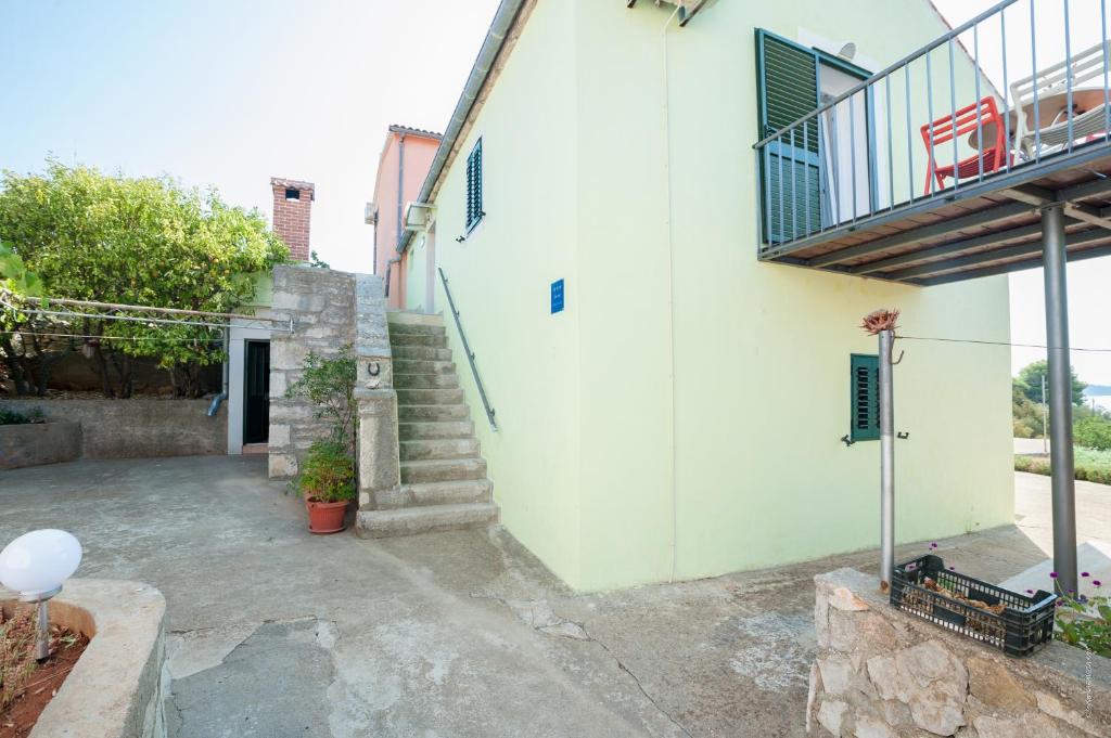 a stairway leading to a building with a balcony at Apartments with a parking space Bozava, Dugi otok - 8124 in Božava