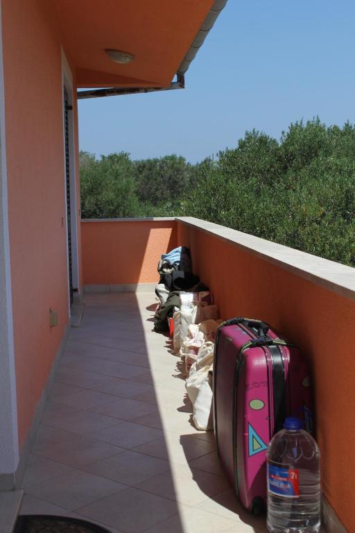 a row of bags of luggage on a wall at Apartments with a parking space Bozava, Dugi otok - 8124 in Božava