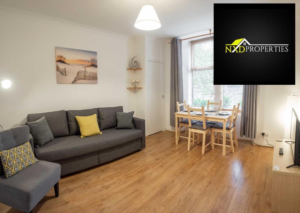 a living room with a couch and a table at ☆ Quiet Ground Floor Apartment Near University ☆ in Dundee