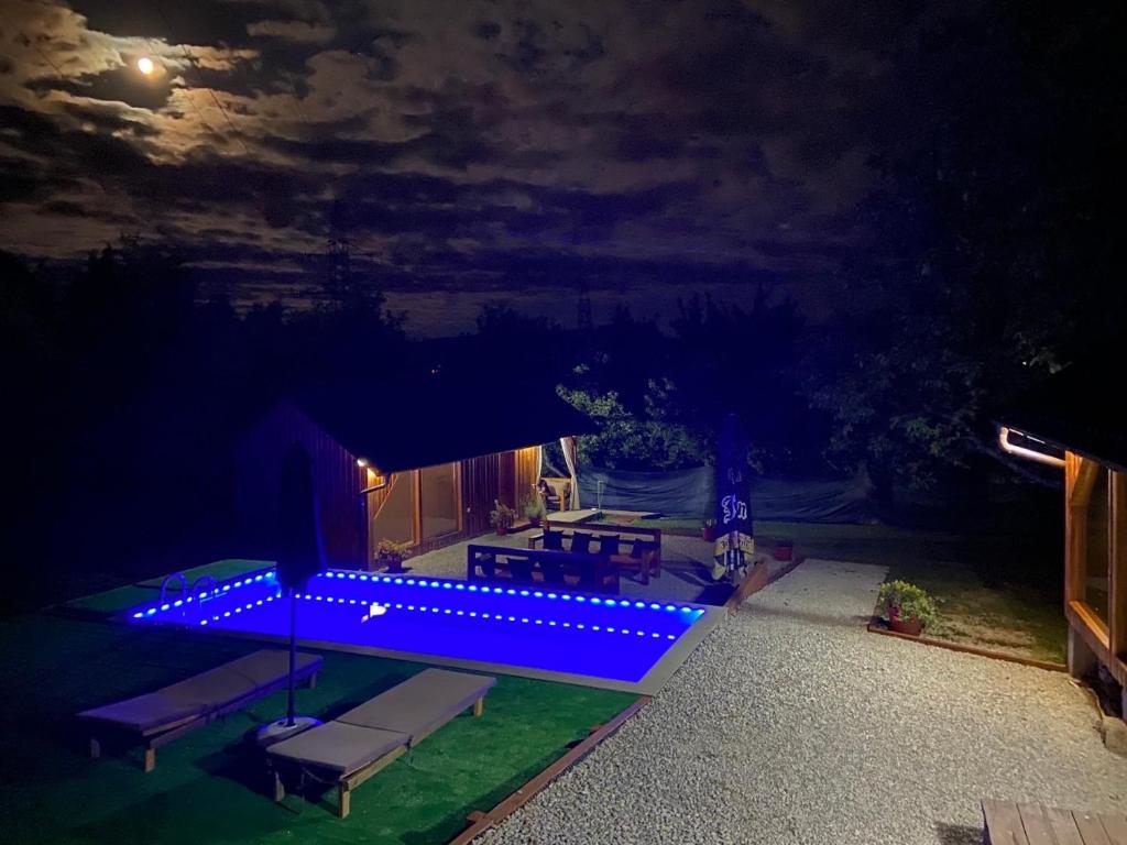 a backyard with a blue lighted patio at night at Hellena in Sarajevo