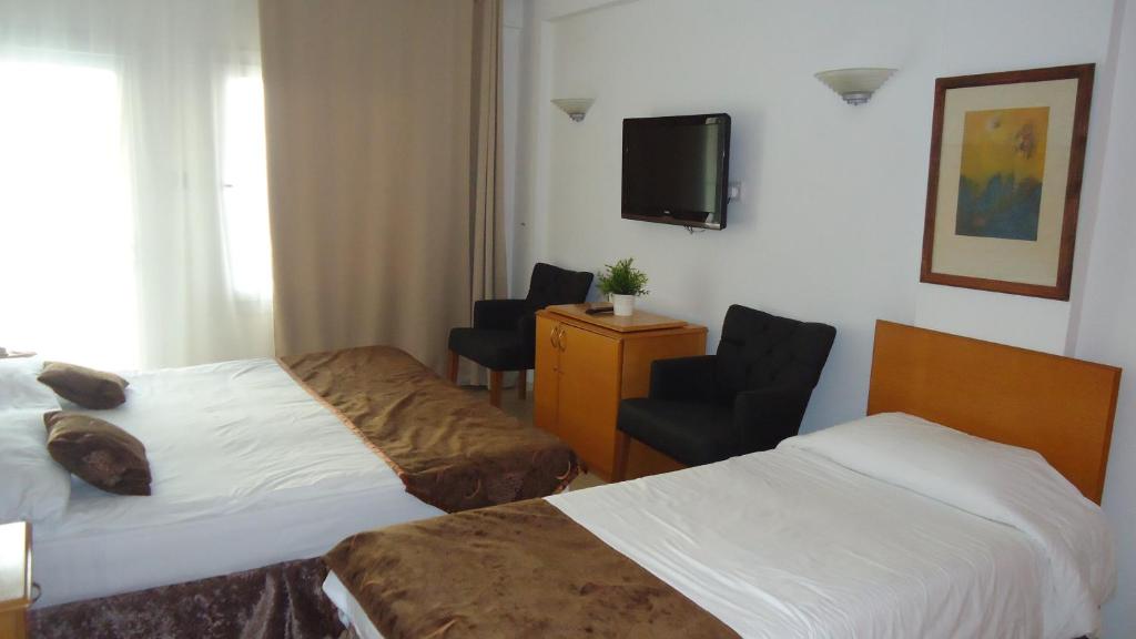Postel nebo postele na pokoji v ubytování Ada Beach Hotel