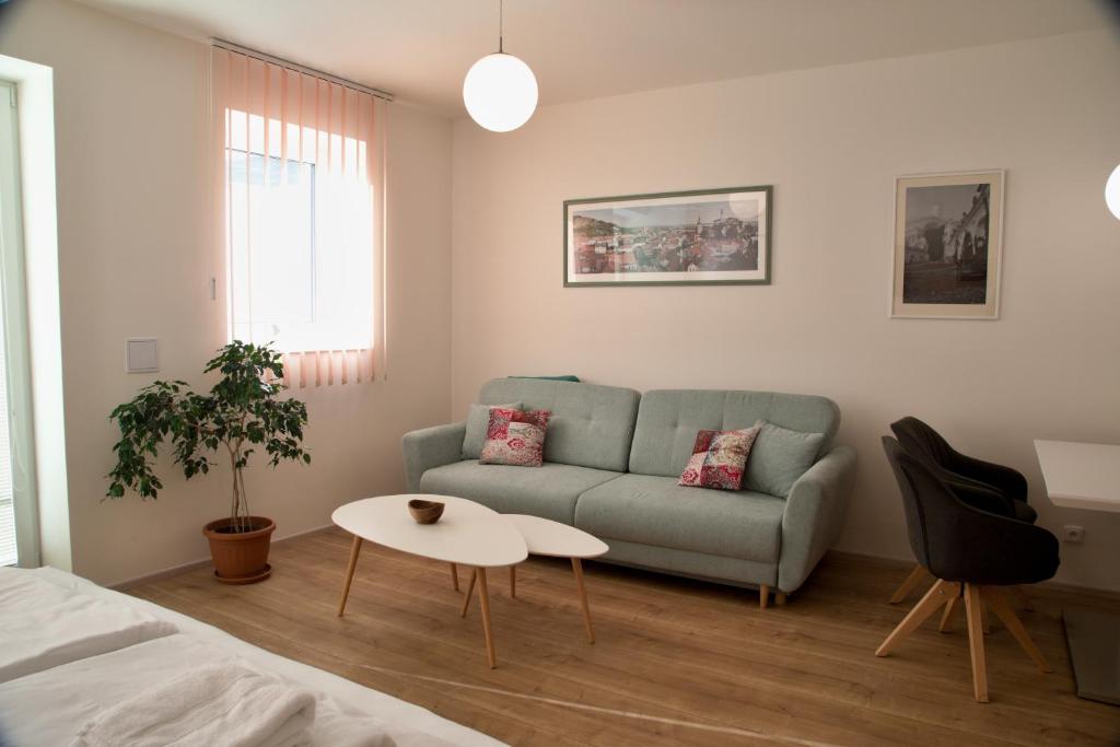 a living room with a couch and a table at Mikulov Apartments - Apartmán Radka in Mikulov