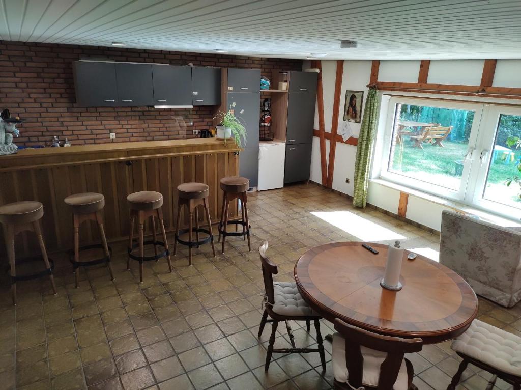 eine Küche mit einem Tisch und einer Bar mit Hockern in der Unterkunft Five Oaks Hamburg in Hamburg