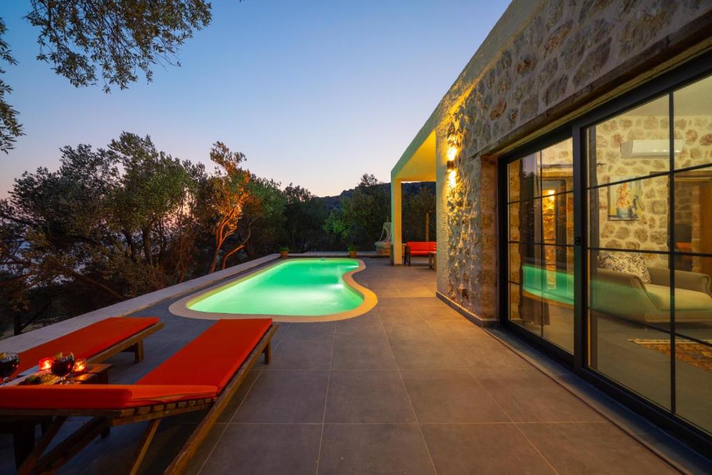 a swimming pool on the side of a house at Villa zeytin patara On the Lycian walking path in Kas