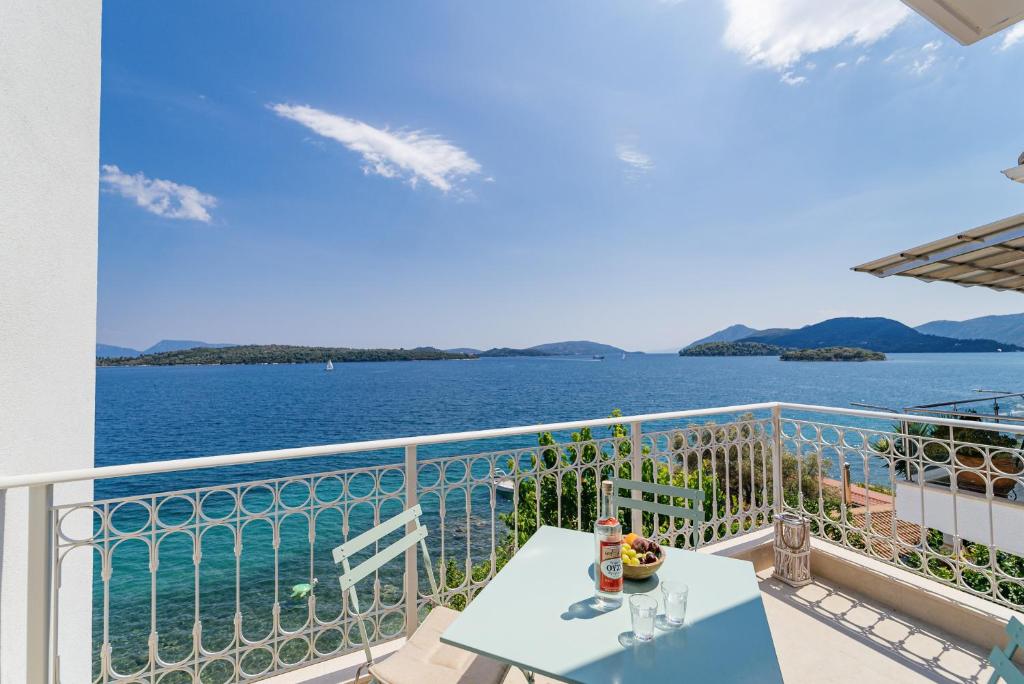 a balcony with a view of the water at Greek Beach House A6 Lefkada in Nydri