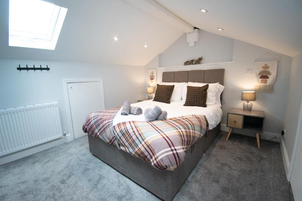 a bedroom with a large bed and a window at Ideal Lodgings in Royton in Royton
