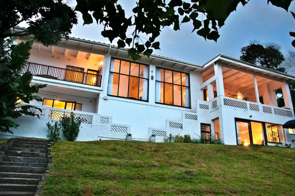 a large white house with a lot of windows at B'Lenghi Beach House in Ballito