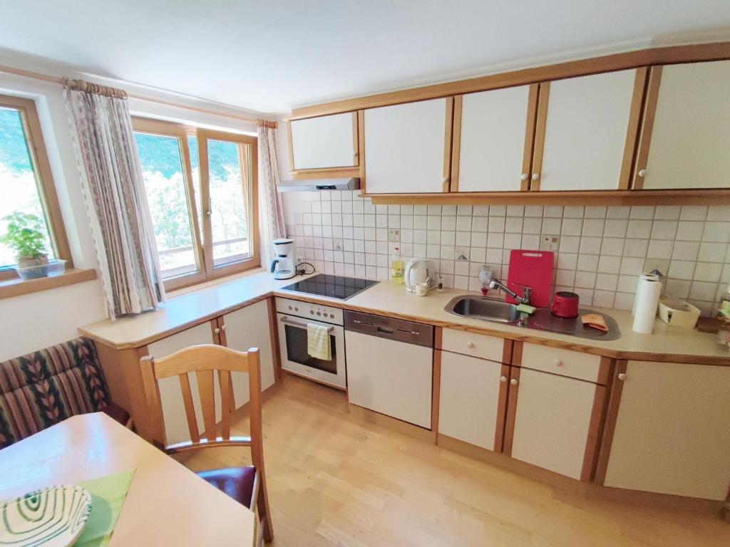 A kitchen or kitchenette at Pretty Holiday Home in Mayerhofen