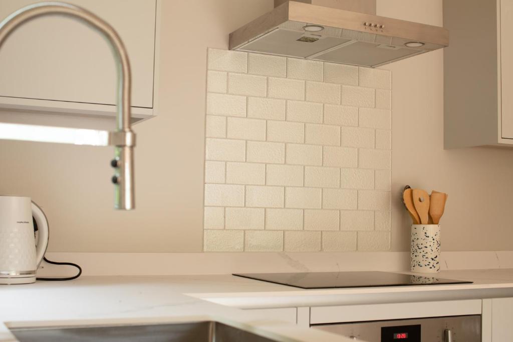 a kitchen with a sink and a counter top at Stylish one bed apartment in the Stroud Valleys in Brimscombe