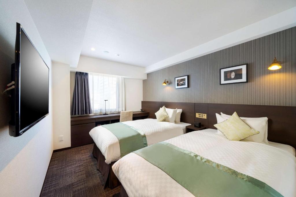 Postel nebo postele na pokoji v ubytování Best Western Hotel Fino Shin-Yokohama
