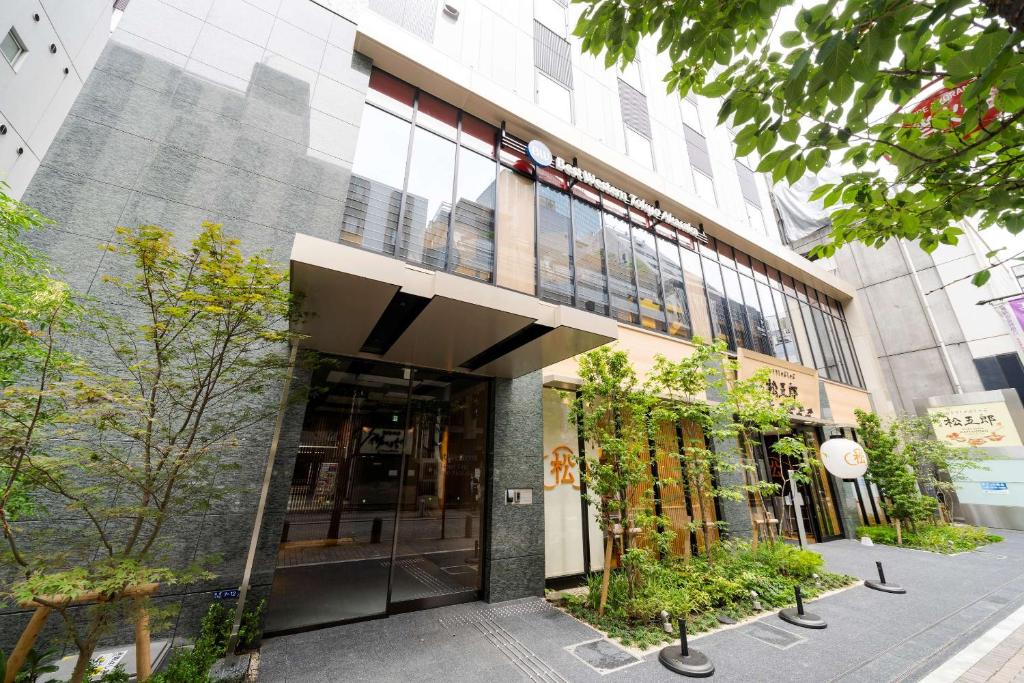 an entrance to a building with plants on the sidewalk at Best Western Hotel Fino Tokyo Akasaka in Tokyo
