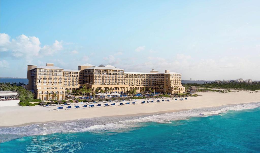 a beach with a large building next to it at Grand Hotel Cancun - Managed by Kempinski in Cancún