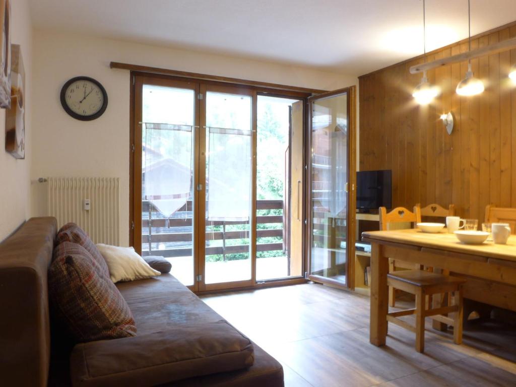 a living room with a couch and a table at Apartment Galaxie 218 by Interhome in Verbier