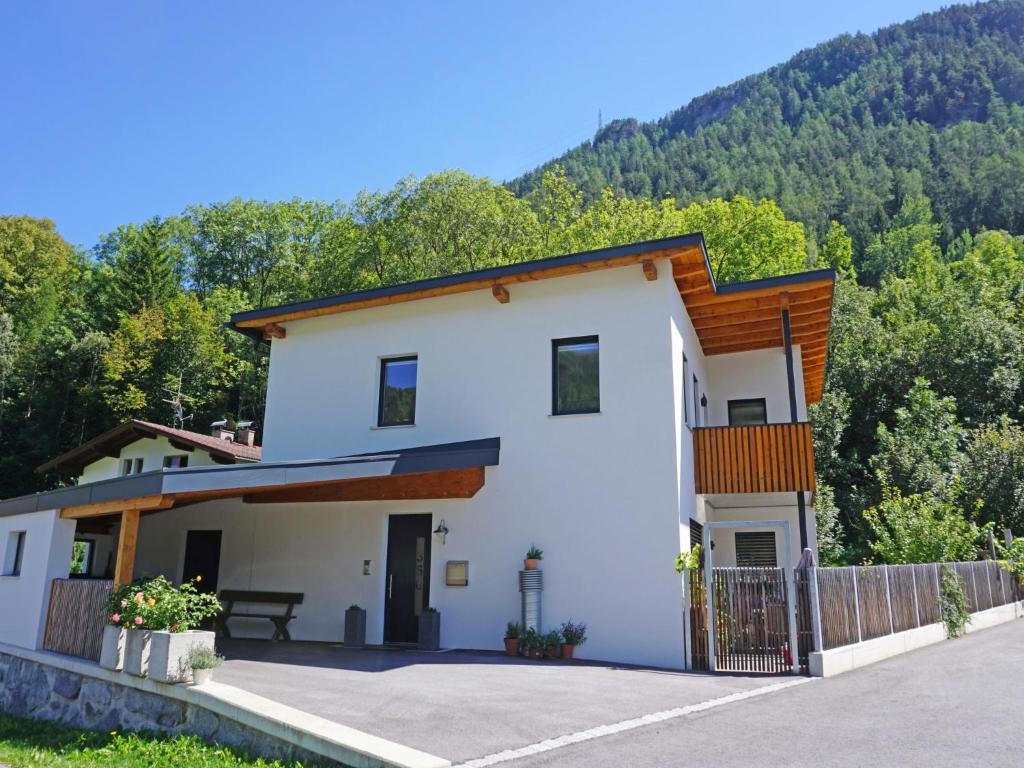 a house in the mountains with a fence at Apartment Matilda by Interhome in Ried im Oberinntal