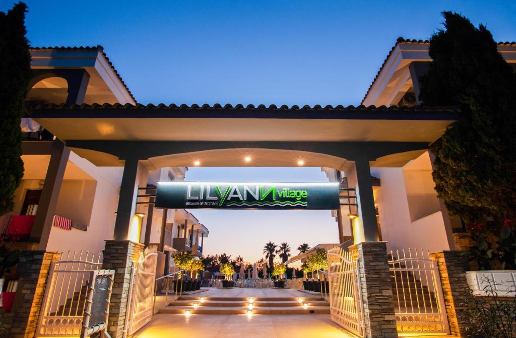 a building with a sign that reads la ivaza at Acrotel Lily Ann Village in Nikiti