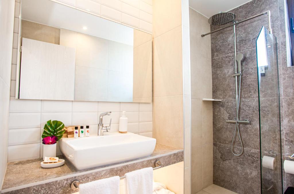 a bathroom with a sink and a shower at Acrotel Lily Ann Village in Nikiti