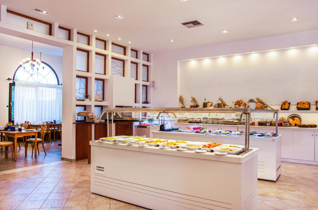 a bakery with a lot of pastries on display at Acrotel Lily Ann Village in Nikiti