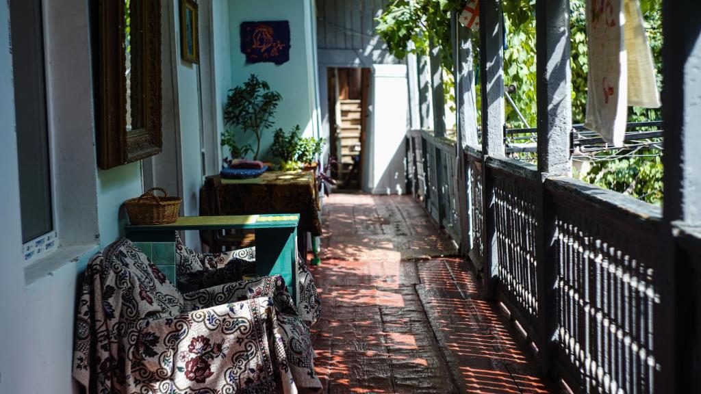 a porch with two benches on a house at Lets Go - Apartment in Tbilisi City