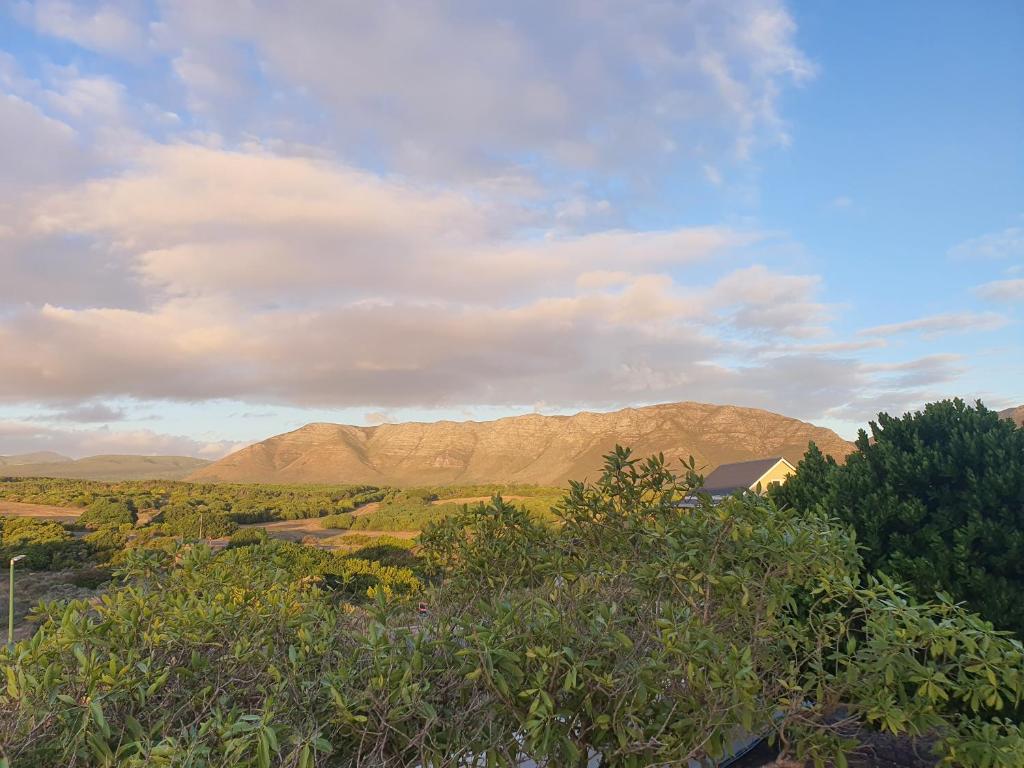 a view of a mountain range with trees and clouds at Bay Haven in Gansbaai