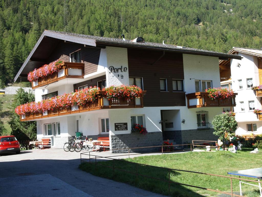 a large building with flowers on the balconies at Ferienhaus Perle in Saas-Grund