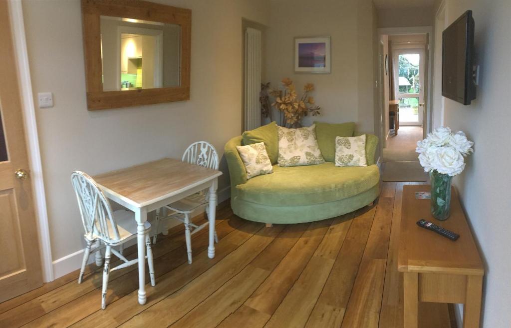 a living room with a couch and a table at Seaside Stay in Rustington