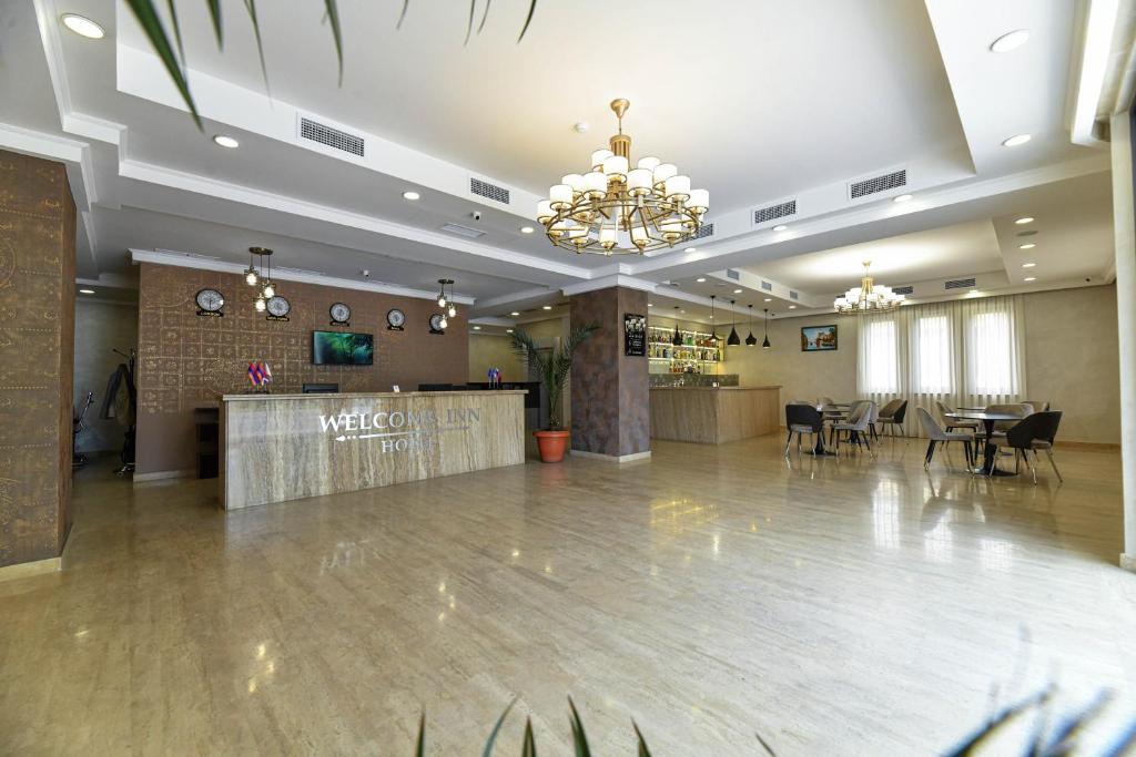 a large lobby with a banquet hall with tables and chairs at Welcome Inn Hotel in Yerevan