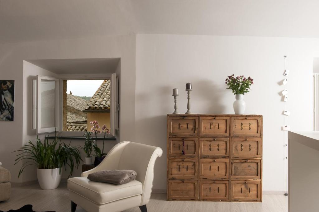 a living room with a chair and a dresser at Appartamento Manassei in Orvieto