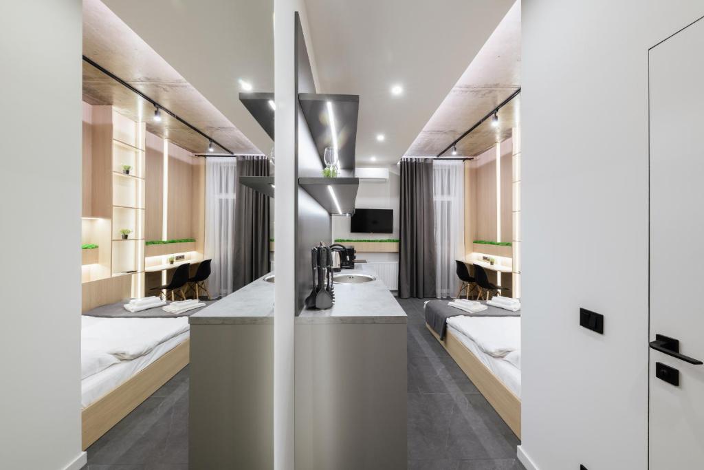 a bathroom with two sinks and a row of mirrors at Luxury Apartments Smart House in Uzhhorod
