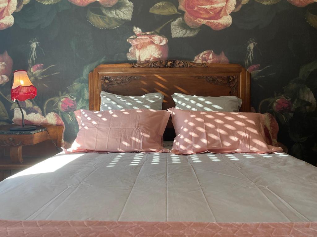 a bedroom with a bed with a floral wallpaper at Chez Paul et Louis in Rodez