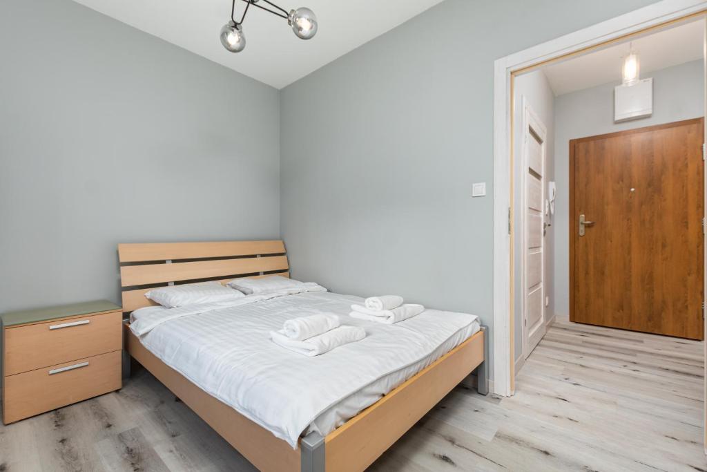 - une chambre avec un lit et 2 serviettes dans l'établissement Łopuszańska 55 by Homeprime, à Varsovie