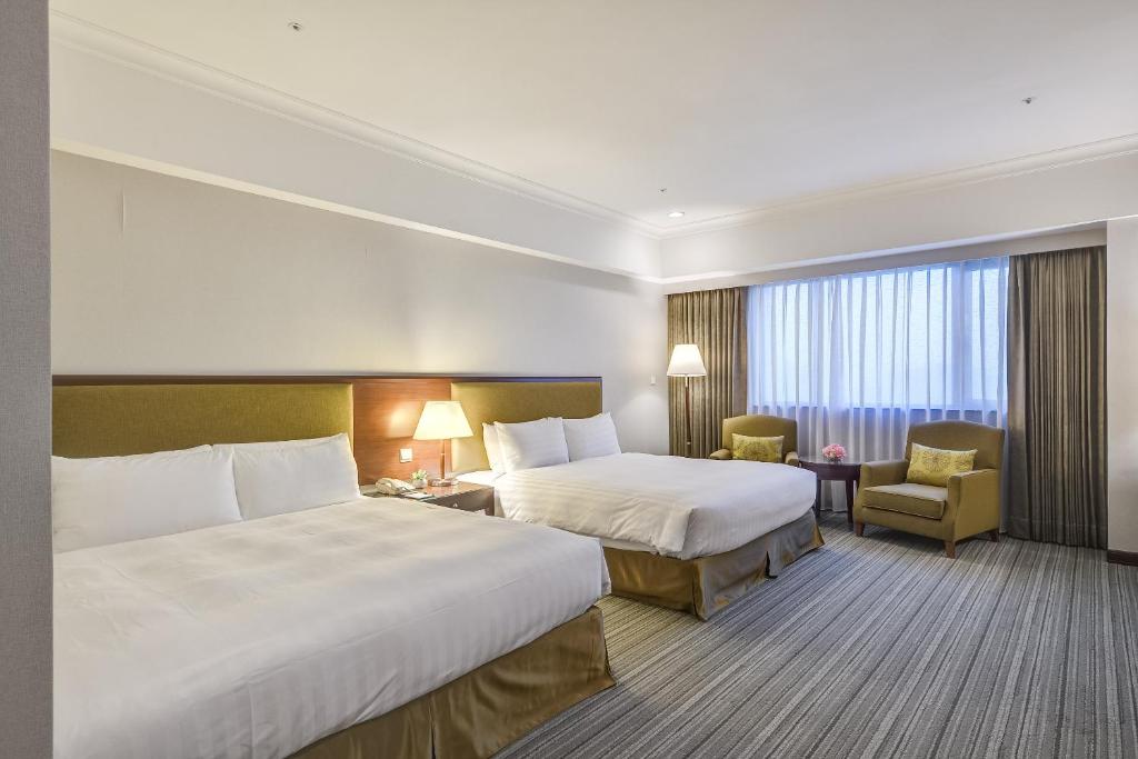 Postel nebo postele na pokoji v ubytování Forte Hotel Xizhi