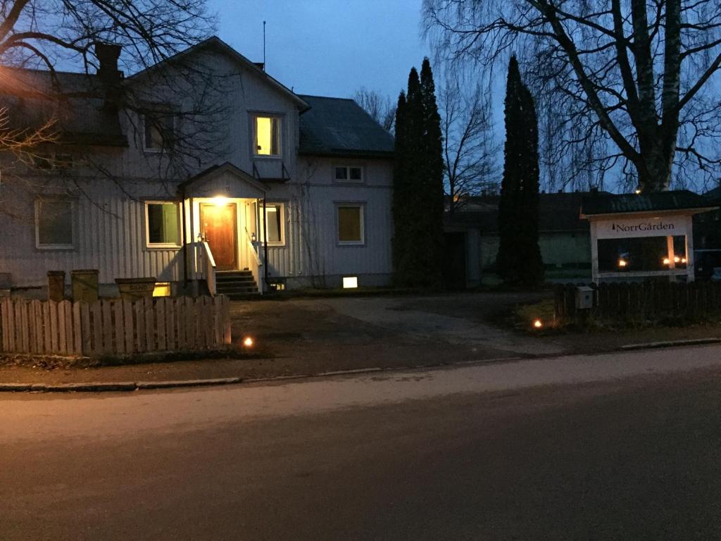 a house with lights on the front door at night at Norrgården i Sandviken in Sandviken
