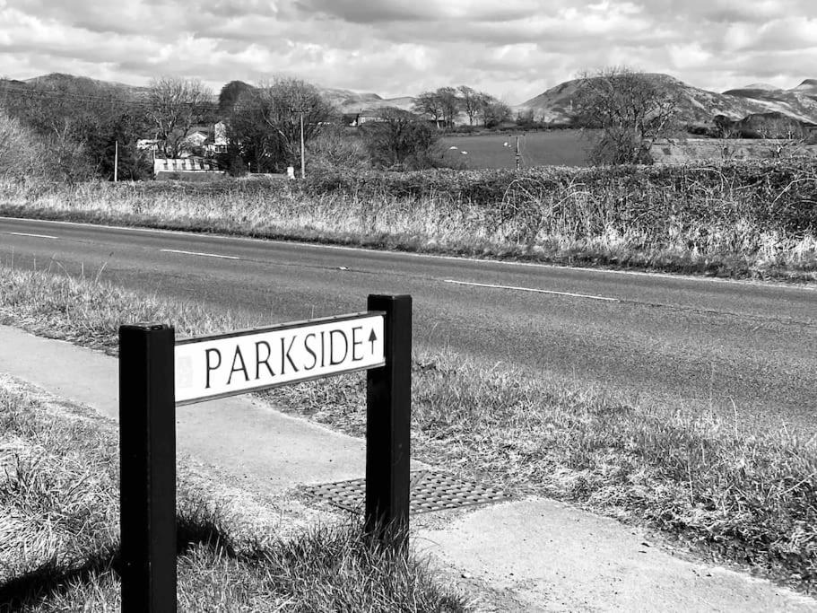 a street sign sitting on the side of a road at Marni’s Cottage - Rural location & fell views in Frizington