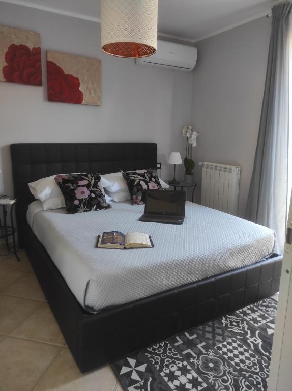 um quarto com uma cama com um computador portátil em Dreams House Paola-luxury suite near airport em Fiumicino