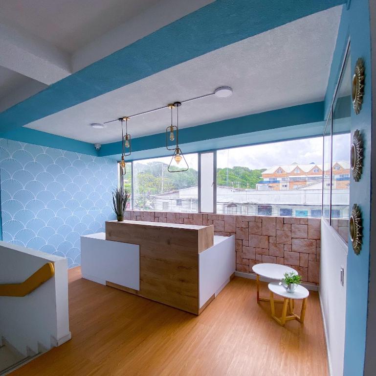 a room with blue walls and a large window at OCEANA HOTEL in San Andrés