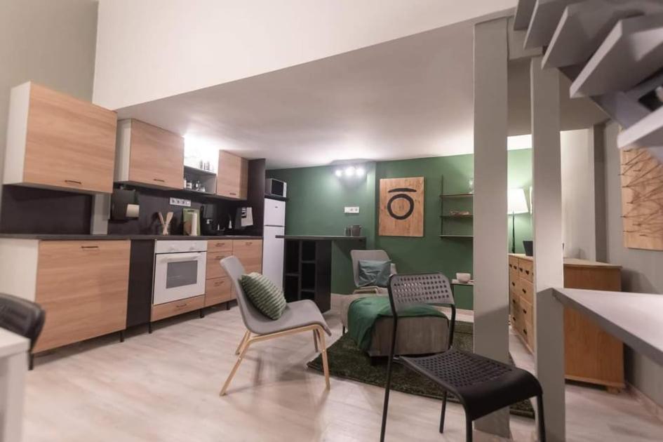 a kitchen with two chairs and a table at Central Stay Gozsdu in Budapest
